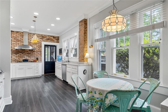 227 S Main St, Honea Path, SC 29654 - kitchen with wall chimney exhaust hood, dishwasher, crown molding, white cabinets, and dark wood finished floors