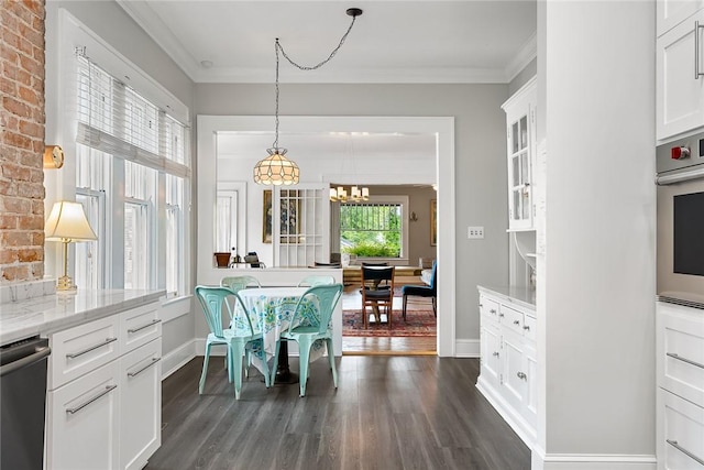 227 S Main St, Honea Path, SC 29654 - dining space with dark wood-type flooring, a chandelier, ornamental molding, and baseboards