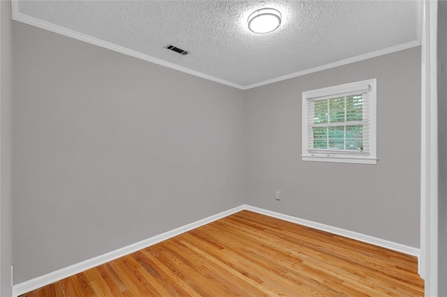 133 Cherokee Rd, Easley, SC 29642 - empty room with light wood-style floors, a textured ceiling, baseboards, and crown molding
