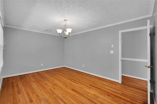 133 Cherokee Rd, Easley, SC 29642 - spare room with a chandelier, a textured ceiling, light wood finished floors, baseboards, and ornamental molding