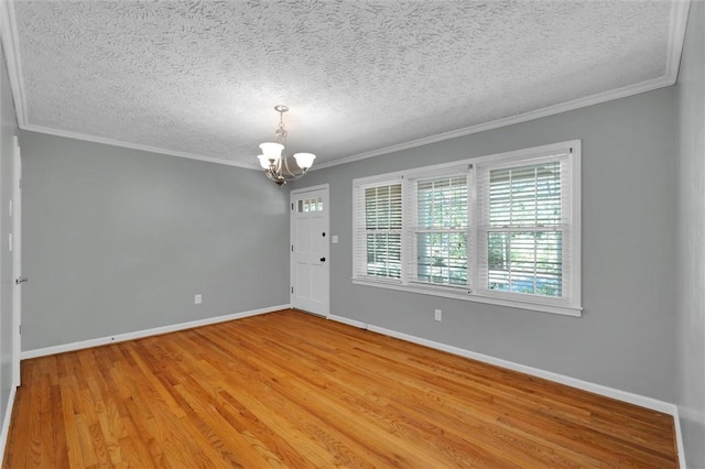 133 Cherokee Rd, Easley, SC 29642 - unfurnished room with a chandelier, crown molding, baseboards, a textured ceiling, and light wood-type flooring