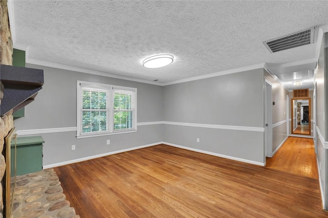 133 Cherokee Rd, Easley, SC 29642 - unfurnished living room featuring wood finished floors, baseboards, a textured ceiling, and ornamental molding