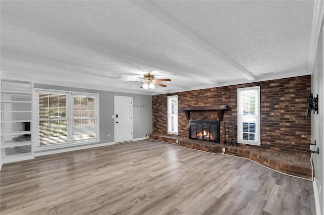 133 Cherokee Rd, Easley, SC 29642 - unfurnished living room with a textured ceiling, wood finished floors, baseboards, a fireplace, and ceiling fan