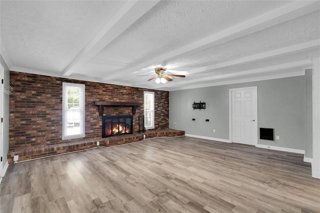 133 Cherokee Rd, Easley, SC 29642 - unfurnished living room featuring a brick fireplace, a ceiling fan, a textured ceiling, wood finished floors, and baseboards