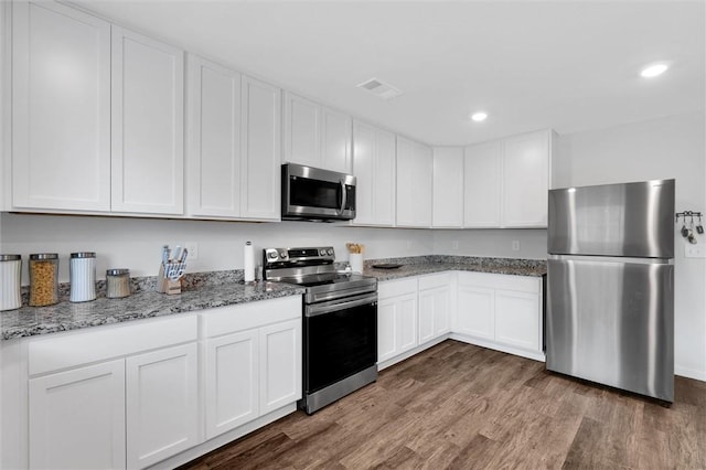 5990 Old Pearman Dairy Rd, Anderson, SC 29625 - kitchen featuring stainless steel appliances, wood finished floors, white cabinets, light stone countertops, and recessed lighting
