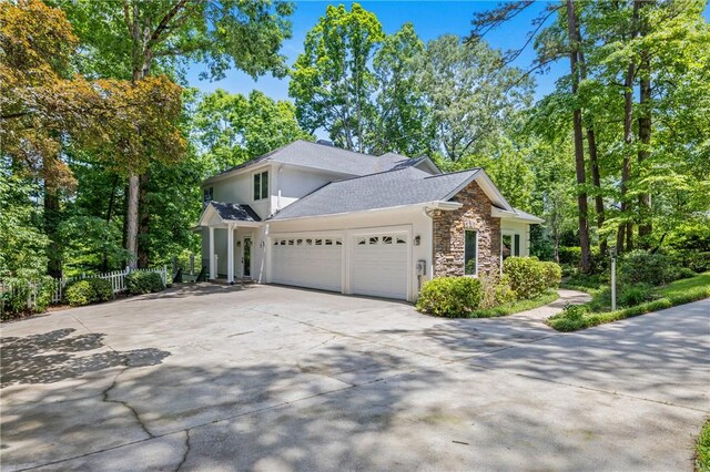 118 Pinnacle Pointe Dr, Seneca, SC 29672 - view of side of property featuring stone siding, a garage, stucco siding, and concrete driveway