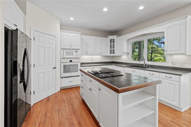 118 Pinnacle Pointe Dr, Seneca, SC 29672 - kitchen featuring black appliances, a sink, white cabinets, light wood-type flooring, and recessed lighting