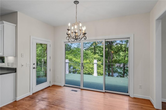 118 Pinnacle Pointe Dr, Seneca, SC 29672 - doorway featuring healthy amount of natural light, wood finished floors, a chandelier, and baseboards