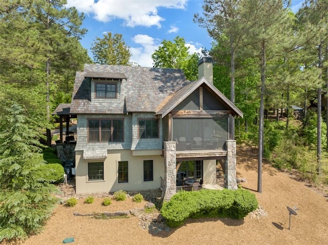 143 Button Bush Trl, Six Mile, SC 29682 - rear view of house with a sunroom, a chimney, and stucco siding