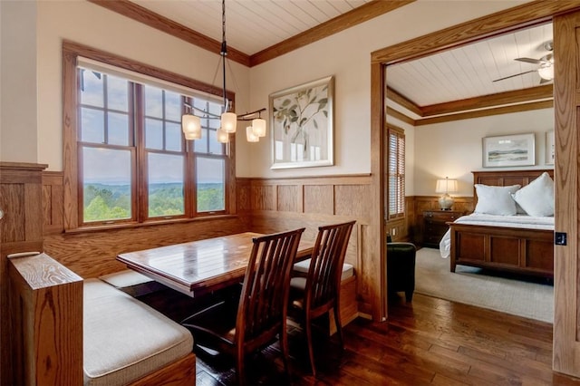 143 Button Bush Trl, Six Mile, SC 29682 - dining area featuring a wainscoted wall, ornamental molding, dark wood finished floors, wood walls, and ceiling fan