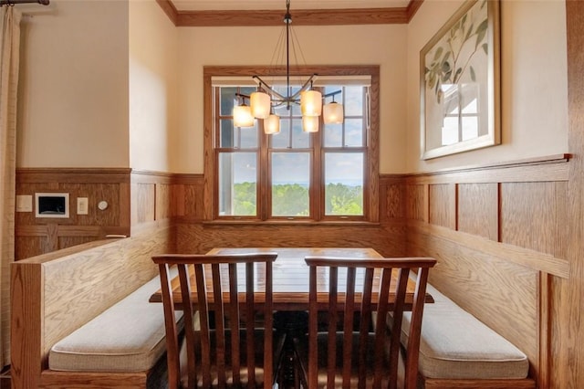 143 Button Bush Trl, Six Mile, SC 29682 - dining space featuring wainscoting, a chandelier, crown molding, and wooden walls