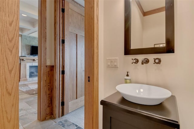 143 Button Bush Trl, Six Mile, SC 29682 - bathroom featuring a large fireplace, ornamental molding, vanity, and beam ceiling