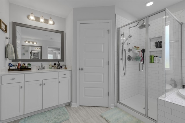 400 N Oak Crest Dr, Belton, SC 29627 - bathroom featuring vanity, a stall shower, tiled tub, baseboards, and recessed lighting