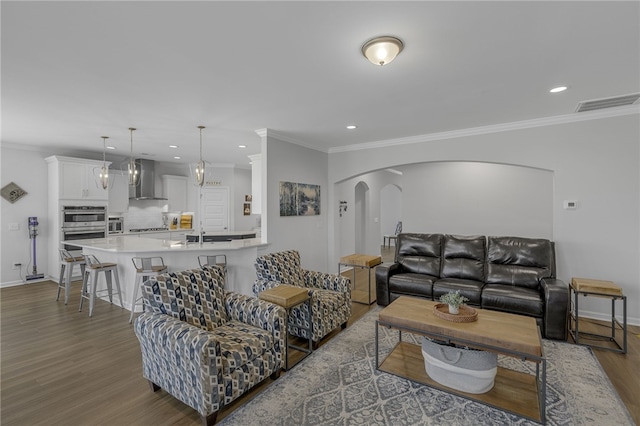 400 N Oak Crest Dr, Belton, SC 29627 - living area with arched walkways, wood finished floors, recessed lighting, baseboards, and ornamental molding