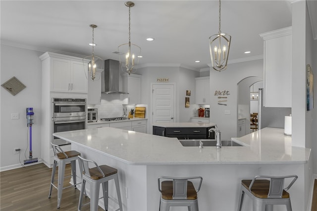 400 N Oak Crest Dr, Belton, SC 29627 - kitchen featuring wall chimney range hood, a sink, dark wood-type flooring, white cabinets, and recessed lighting