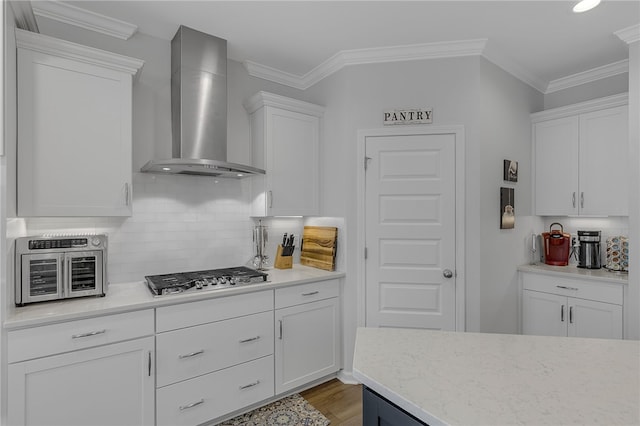400 N Oak Crest Dr, Belton, SC 29627 - kitchen featuring wall chimney range hood, stainless steel gas cooktop, white cabinetry, decorative backsplash, and crown molding