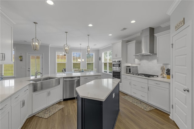 400 N Oak Crest Dr, Belton, SC 29627 - kitchen with wall chimney range hood, stainless steel appliances, a sink, crown molding, and light countertops