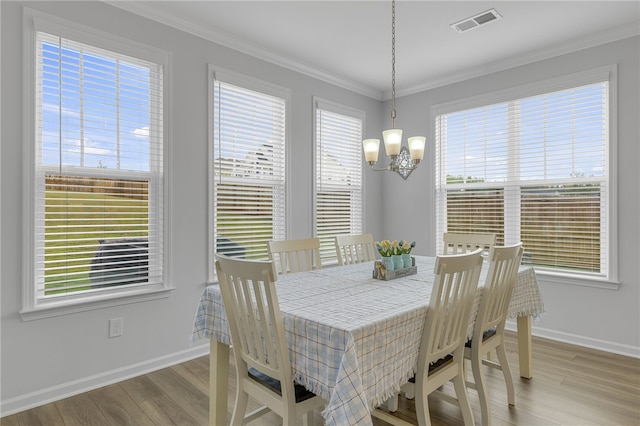 400 N Oak Crest Dr, Belton, SC 29627 - dining space featuring plenty of natural light, wood finished floors, a chandelier, and ornamental molding