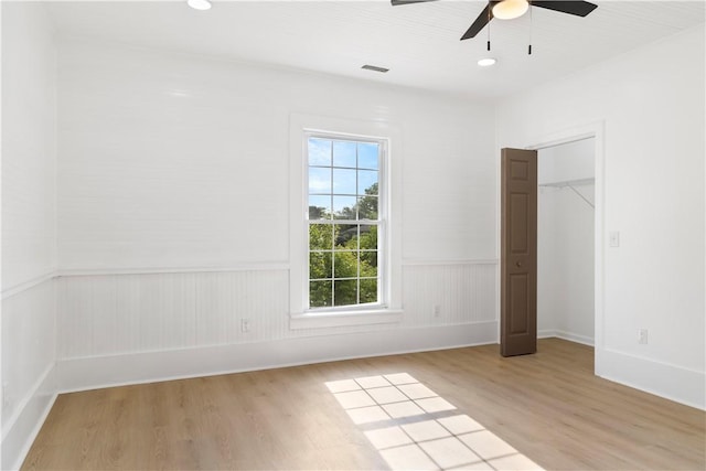 701 S Townville St, Seneca, SC 29678 - unfurnished bedroom featuring light wood-type flooring, wainscoting, a ceiling fan, and recessed lighting