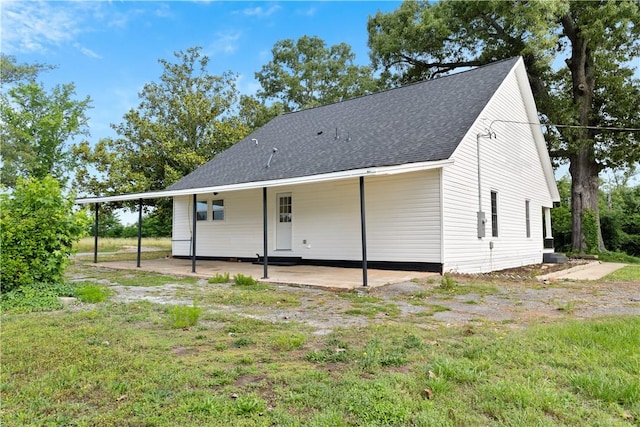 701 S Townville St, Seneca, SC 29678 - rear view of property featuring a shingled roof, a patio, and a carport