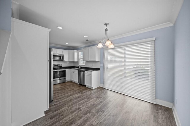 406 Bee Cove Way, Pendleton, SC 29670 - kitchen featuring appliances with stainless steel finishes, ornamental molding, dark countertops, white cabinetry, and baseboards