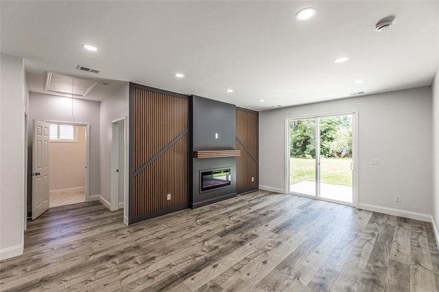 107A Avondale Rd, Anderson, SC 29624 - unfurnished living room with attic access, healthy amount of natural light, wood finished floors, and recessed lighting