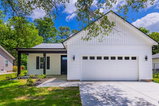 107A Avondale Rd, Anderson, SC 29624 - view of front of house with board and batten siding, a garage, a front lawn, driveway, and covered porch