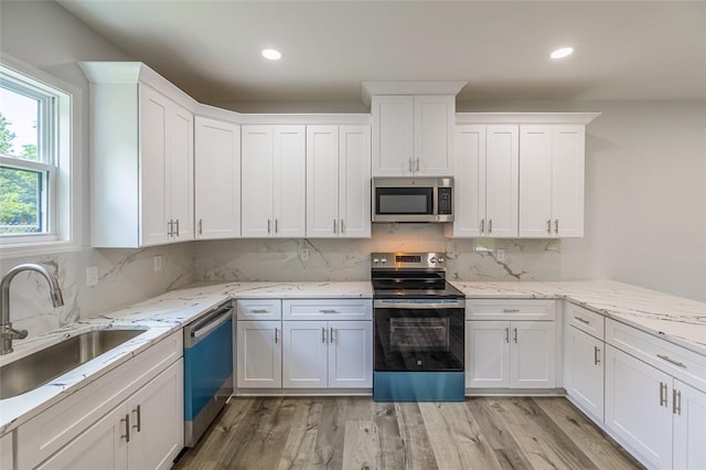 107A Avondale Rd, Anderson, SC 29624 - kitchen featuring stainless steel appliances, a sink, tasteful backsplash, white cabinets, and light wood finished floors
