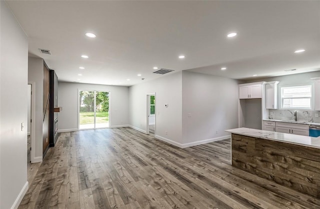107A Avondale Rd, Anderson, SC 29624 - unfurnished living room featuring wood finished floors, recessed lighting, plenty of natural light, and baseboards