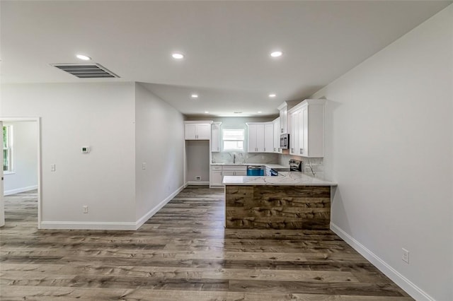 107A Avondale Rd, Anderson, SC 29624 - kitchen with appliances with stainless steel finishes, white cabinetry, baseboards, dark wood finished floors, and a peninsula