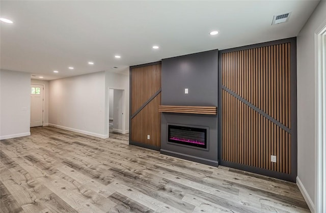 107A Avondale Rd, Anderson, SC 29624 - unfurnished living room featuring baseboards, wood finished floors, recessed lighting, and a glass covered fireplace