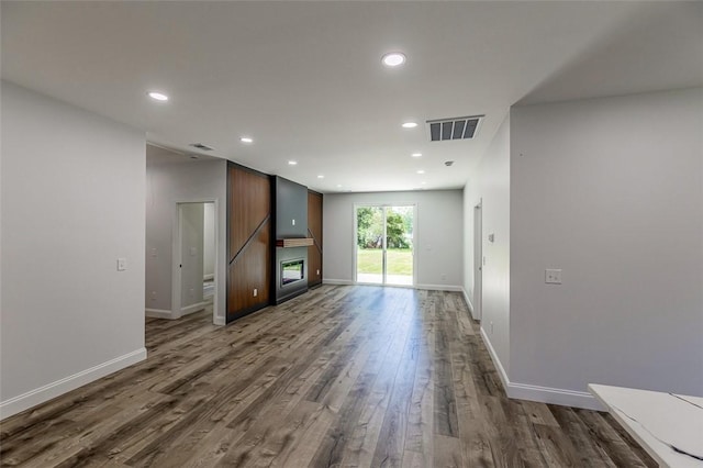 107A Avondale Rd, Anderson, SC 29624 - unfurnished living room featuring dark wood-style flooring, recessed lighting, baseboards, and a glass covered fireplace