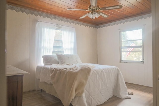 504 Suttles Landing Rd, Iva, SC 29655 - bedroom featuring wooden ceiling, light wood-style flooring, multiple windows, a ceiling fan, and wood walls