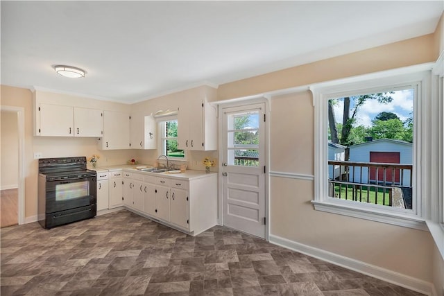 2400 Lane Ave, Anderson, SC 29621 - kitchen with black / electric stove, a sink, light countertops, baseboards, and white cabinetry