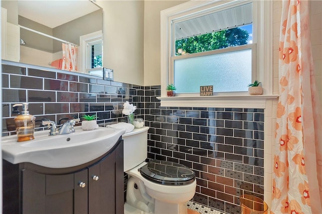 2400 Lane Ave, Anderson, SC 29621 - bathroom featuring tile walls, vanity, toilet, a shower with shower curtain, and a wainscoted wall