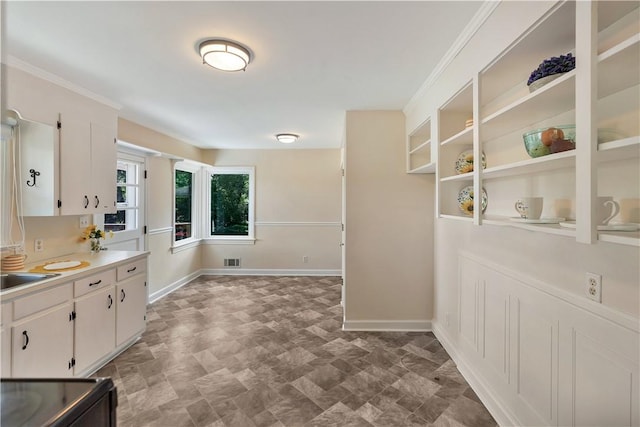 2400 Lane Ave, Anderson, SC 29621 - kitchen featuring light countertops, baseboards, white cabinets, and ornamental molding