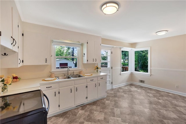 2400 Lane Ave, Anderson, SC 29621 - kitchen with a sink, electric range, white cabinetry, and light countertops