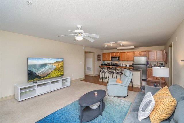1523 Gadwell Way, Seneca, SC 29678 - living area featuring light carpet, ceiling fan, baseboards, and a textured ceiling