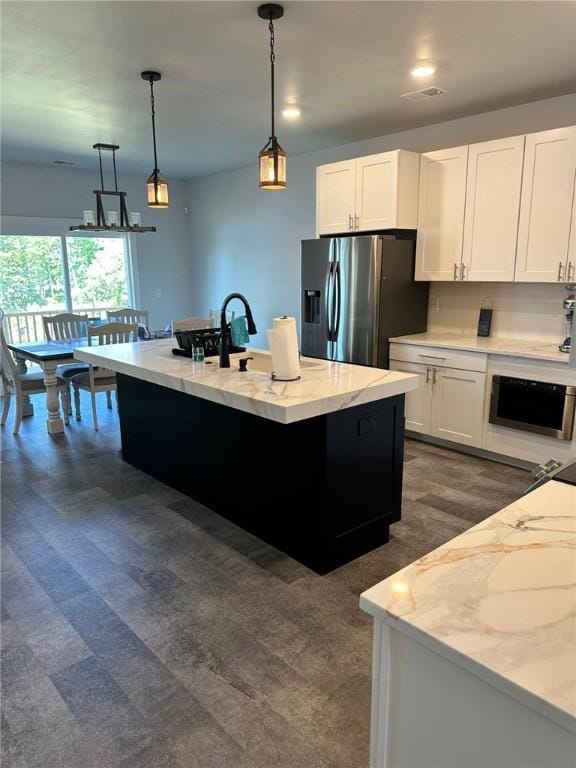 70 Creek Point Dr, Abbeville, SC 29620 - kitchen featuring stainless steel fridge with ice dispenser, white cabinetry, hanging light fixtures, an island with sink, and light stone countertops