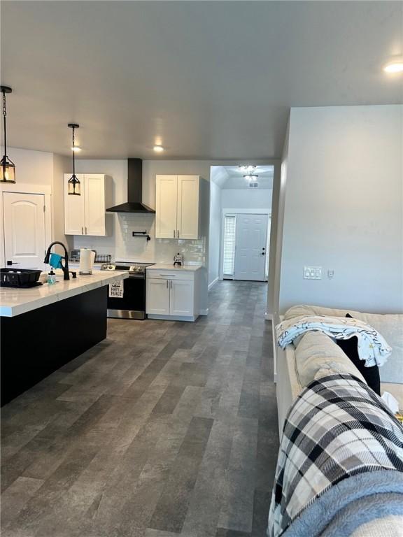 70 Creek Point Dr, Abbeville, SC 29620 - kitchen with wall chimney exhaust hood, stainless steel electric stove, light countertops, white cabinetry, and pendant lighting