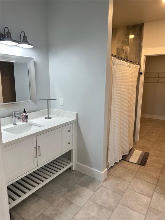 70 Creek Point Dr, Abbeville, SC 29620 - bathroom featuring vanity, tile patterned flooring, a shower with shower curtain, and baseboards