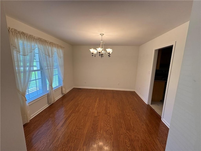 106 Dewars Trl, Anderson, SC 29621 - spare room featuring a chandelier, dark wood-style floors, and baseboards