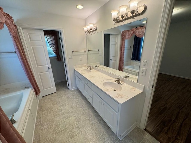 106 Dewars Trl, Anderson, SC 29621 - bathroom featuring a tub, double vanity, baseboards, a shower with shower curtain, and a chandelier