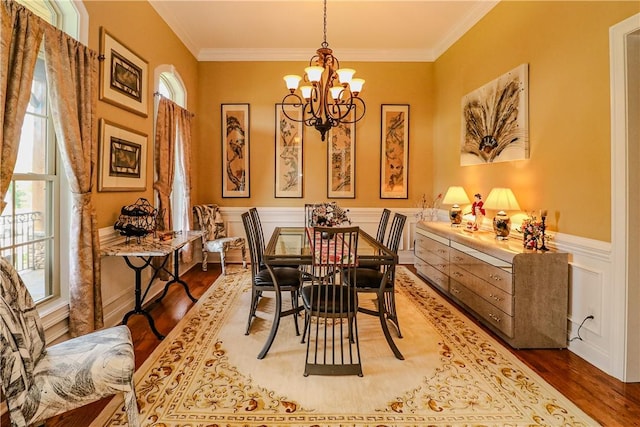 122 Langwell Dr, Anderson, SC 29621 - dining space with a chandelier, wood finished floors, crown molding, wainscoting, and a decorative wall