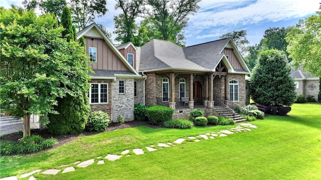 122 Langwell Dr, Anderson, SC 29621 - craftsman-style house with board and batten siding, a porch, a front lawn, and stone siding