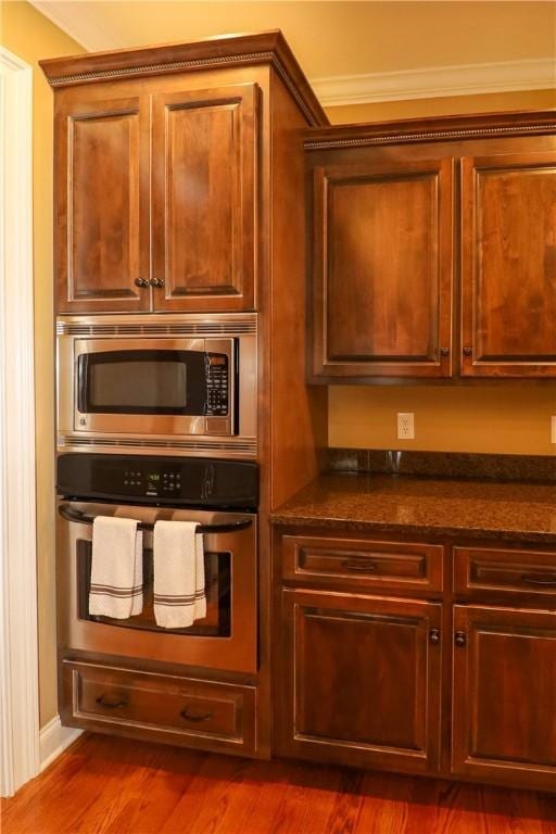 122 Langwell Dr, Anderson, SC 29621 - kitchen featuring stainless steel appliances, dark wood finished floors, ornamental molding, and dark stone counters