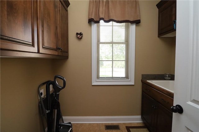 122 Langwell Dr, Anderson, SC 29621 - laundry room featuring baseboards, a sink, and light tile patterned floors