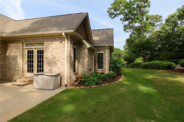 122 Langwell Dr, Anderson, SC 29621 - view of home's exterior with a yard, roof with shingles, brick siding, board and batten siding, and a patio area