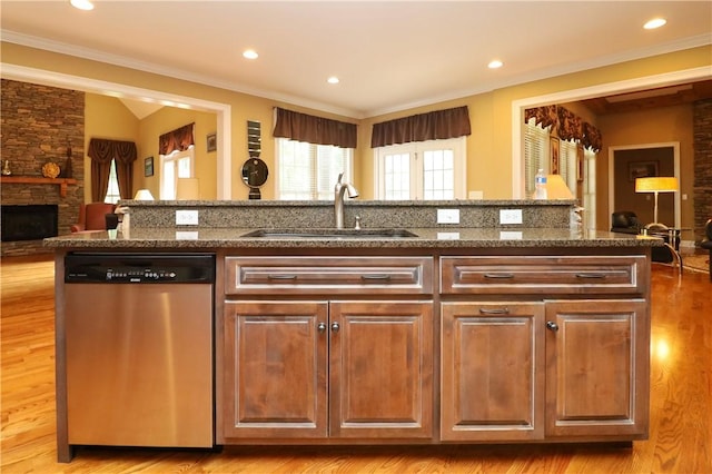 122 Langwell Dr, Anderson, SC 29621 - kitchen featuring dishwasher, a sink, dark stone counters, crown molding, and a stone fireplace