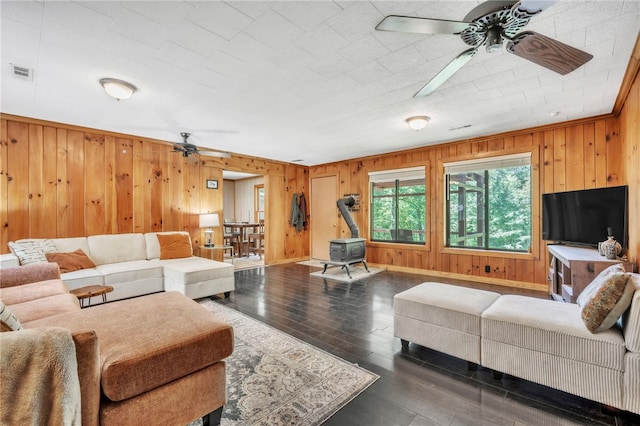 466 Whetstone Rd, Mountain Rest, SC 29664 - living area with a ceiling fan, a wood stove, wood walls, wood-type flooring, and baseboards